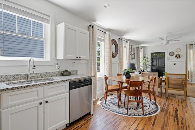 170 Spring St, Charleston, SC 29403 - kitchen with stainless steel dishwasher, white cabinetry, light wood-style flooring, light stone countertops, and recessed lighting
