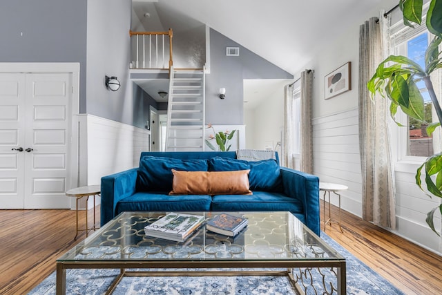 170 Spring St, Charleston, SC 29403 - living room with wood finished floors, vaulted ceiling, wooden walls, and a wainscoted wall
