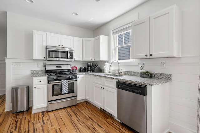 170 Spring St, Charleston, SC 29403 - kitchen with stainless steel appliances, white cabinetry, and recessed lighting