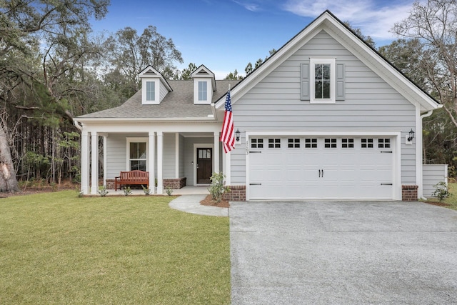 view of front of house with a porch, a garage, and a front yard