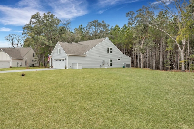 view of property exterior with a garage and a yard