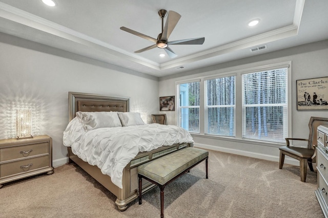 carpeted bedroom featuring a raised ceiling, crown molding, and ceiling fan