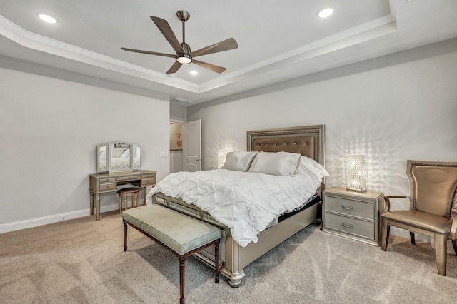 carpeted bedroom with crown molding, a tray ceiling, and ceiling fan