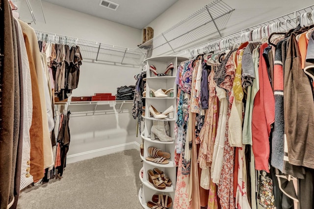 walk in closet featuring carpet flooring