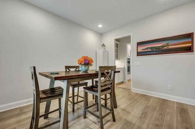 dining area featuring light wood-type flooring