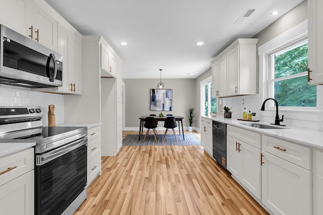 6305 Lucille Dr, North Charleston, SC 29406 - kitchen featuring stainless steel appliances, a sink, light countertops, tasteful backsplash, and recessed lighting
