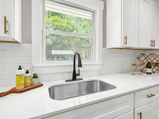 6305 Lucille Dr, North Charleston, SC 29406 - kitchen featuring a sink, white cabinetry, decorative backsplash, and light stone countertops