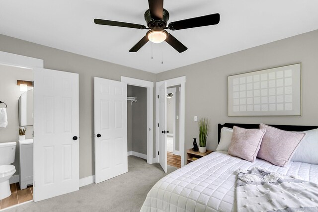 6305 Lucille Dr, North Charleston, SC 29406 - bedroom with light colored carpet, a walk in closet, ensuite bathroom, ceiling fan, and baseboards