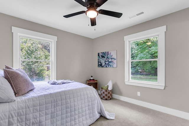 6305 Lucille Dr, North Charleston, SC 29406 - carpeted bedroom featuring multiple windows, baseboards, and ceiling fan