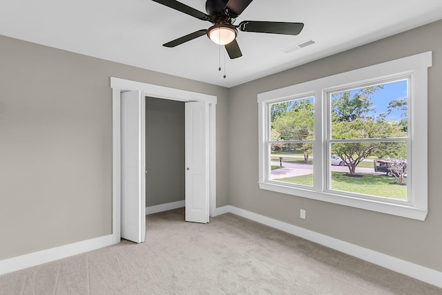 6305 Lucille Dr, North Charleston, SC 29406 - unfurnished bedroom with light colored carpet, baseboards, multiple windows, and a closet