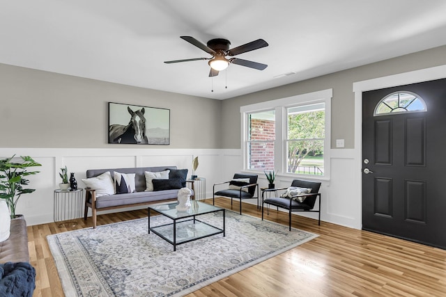 6305 Lucille Dr, North Charleston, SC 29406 - living room featuring a wainscoted wall, a ceiling fan, and light wood finished floors