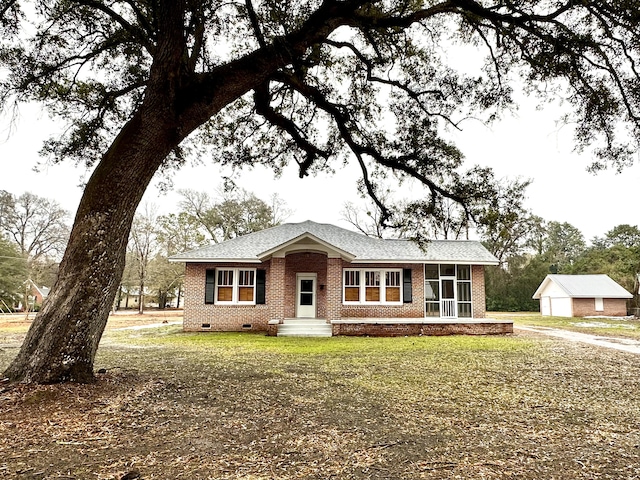 ranch-style house featuring a sunroom and a front yard