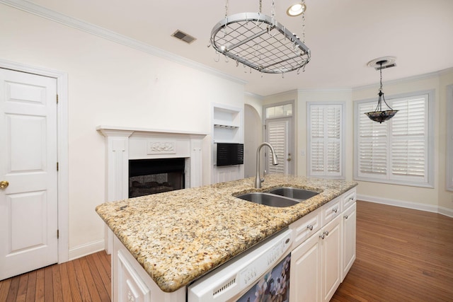 kitchen with sink, hardwood / wood-style floors, white dishwasher, a center island with sink, and white cabinets