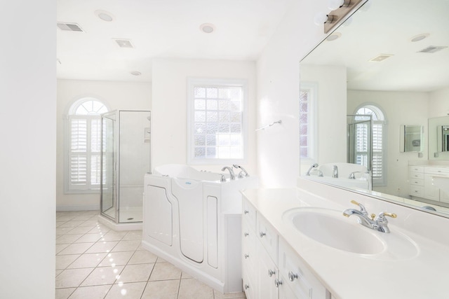 bathroom featuring tile patterned floors, vanity, and separate shower and tub