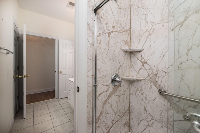 bathroom with tile patterned floors and a shower with shower door