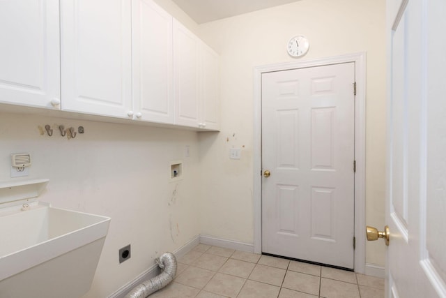 laundry area featuring sink, cabinets, hookup for an electric dryer, hookup for a washing machine, and light tile patterned floors