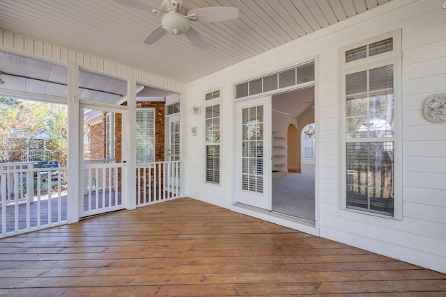 unfurnished sunroom featuring ceiling fan