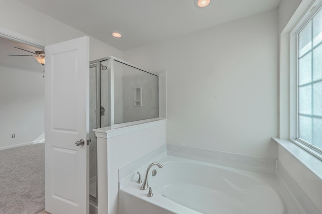 bathroom featuring a wealth of natural light, independent shower and bath, and ceiling fan