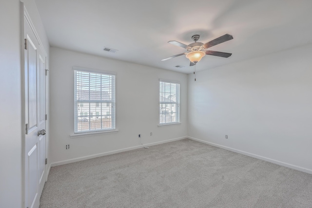 spare room with light carpet and ceiling fan