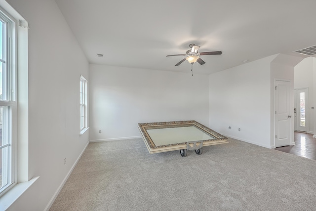 unfurnished room with carpet and ceiling fan