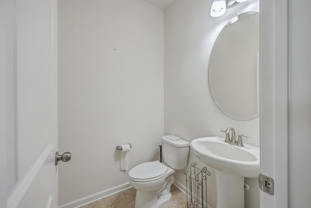 bathroom with sink, tile patterned flooring, and toilet