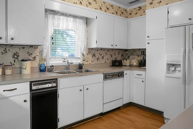 kitchen featuring white appliances, sink, light wood-type flooring, white cabinetry, and ornamental molding