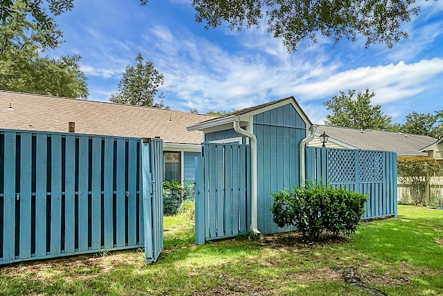 view of outbuilding featuring a lawn