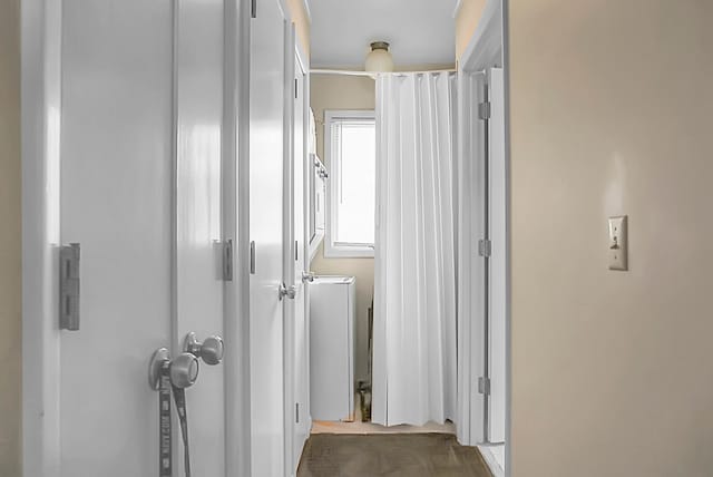 hallway featuring light colored carpet