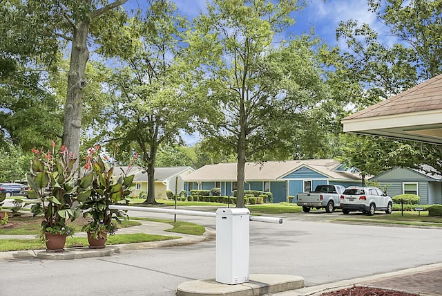 view of road featuring sidewalks, a residential view, and curbs