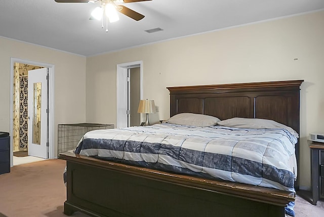 bedroom featuring a ceiling fan, visible vents, and light colored carpet