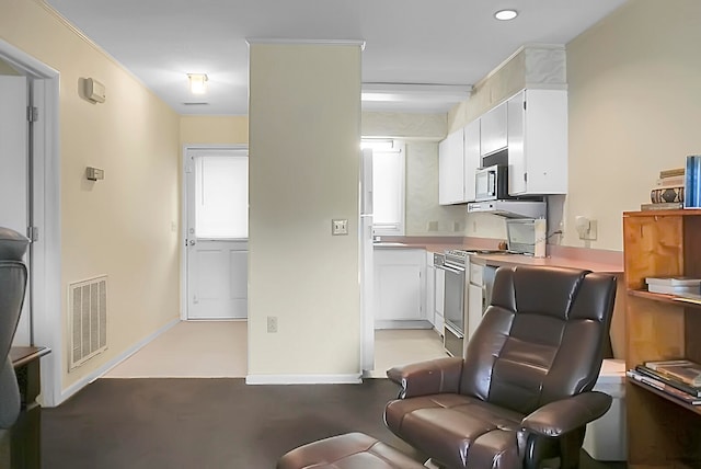 interior space featuring white cabinetry and stainless steel appliances