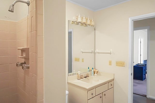 bathroom featuring ornamental molding, vanity, and toilet