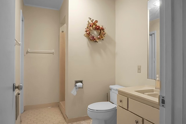 bathroom featuring vanity, tile patterned flooring, and toilet