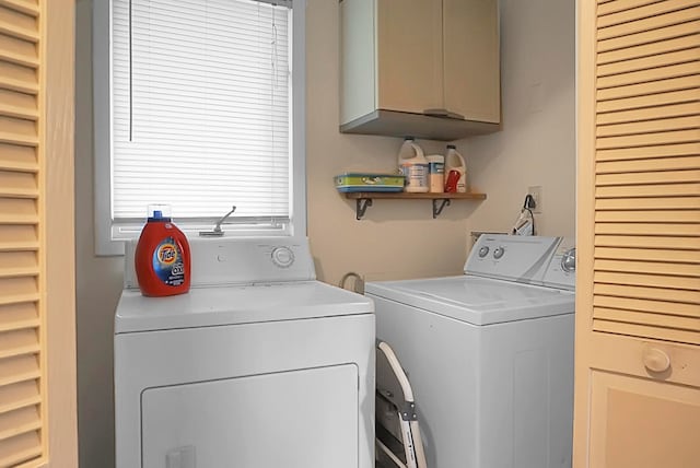 laundry room featuring cabinets and washer and dryer