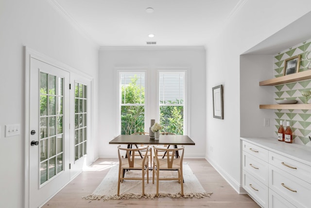 7053 Schooner St, Daniel Island, SC 29492 - dining space with healthy amount of natural light, crown molding, light wood-style floors, and baseboards