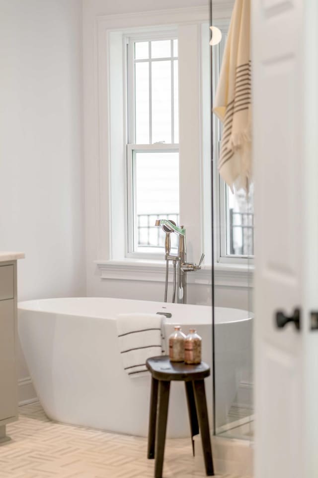 7053 Schooner St, Daniel Island, SC 29492 - bathroom featuring healthy amount of natural light, a freestanding tub, and vanity