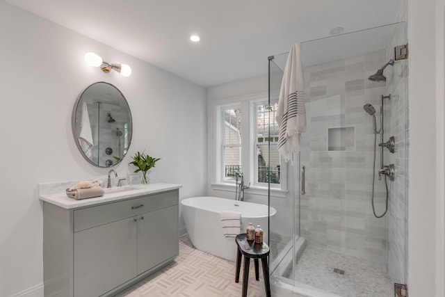 7053 Schooner St, Daniel Island, SC 29492 - bathroom featuring a stall shower, a soaking tub, vanity, recessed lighting, and baseboards