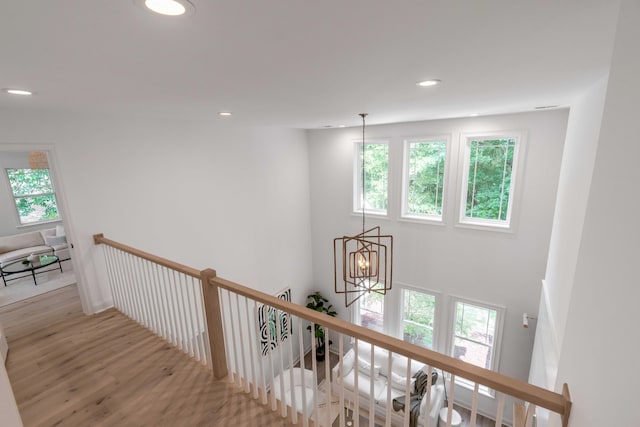 7053 Schooner St, Daniel Island, SC 29492 - corridor featuring an upstairs landing, wood finished floors, recessed lighting, and a chandelier