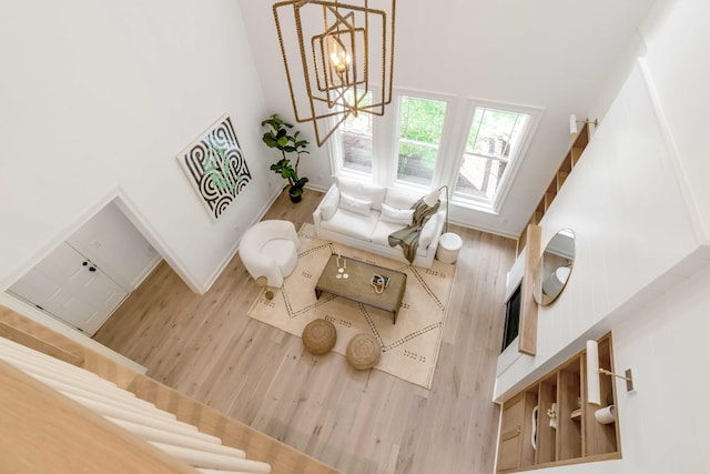 7053 Schooner St, Daniel Island, SC 29492 - living area featuring a towering ceiling, wood finished floors, and a chandelier