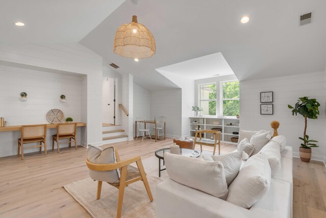 7053 Schooner St, Daniel Island, SC 29492 - living room featuring lofted ceiling, stairs, light wood-style floors, wooden walls, and recessed lighting