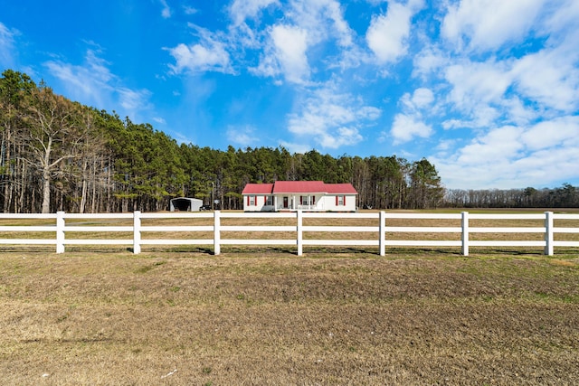 view of yard featuring fence and a rural view