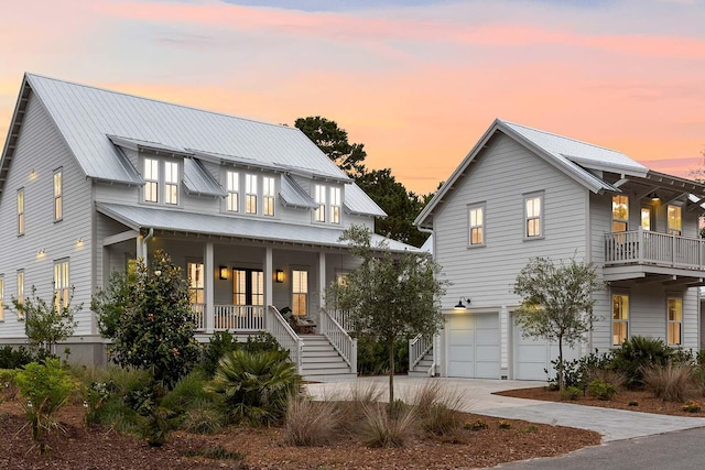 3023 Eventide Dr, Johns Island, SC 29455 - view of front facade featuring covered porch, stairs, an attached garage, metal roof, and driveway