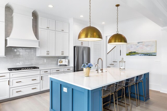 3023 Eventide Dr, Johns Island, SC 29455 - kitchen with custom exhaust hood, stainless steel refrigerator, gas cooktop, light wood-style floors, and recessed lighting