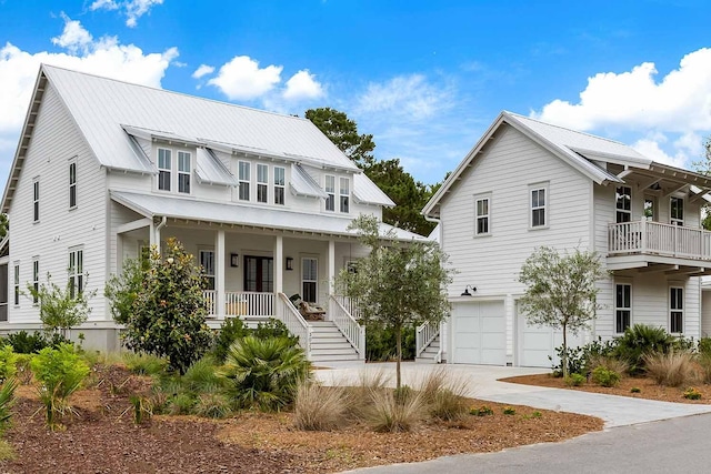 3023 Eventide Dr, Johns Island, SC 29455 - view of front facade with an attached garage, covered porch, stairway, driveway, and metal roof