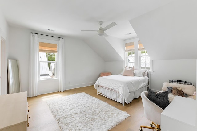 3023 Eventide Dr, Johns Island, SC 29455 - bedroom featuring multiple windows, light wood-style flooring, vaulted ceiling, and a ceiling fan