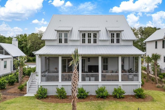 3023 Eventide Dr, Johns Island, SC 29455 - view of front facade featuring a sunroom, a front yard, stairway, and metal roof