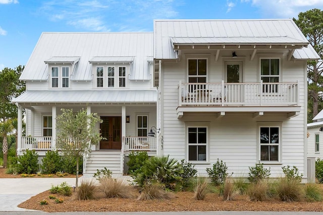 3023 Eventide Dr, Johns Island, SC 29455 - view of front of house featuring covered porch, a balcony, and metal roof