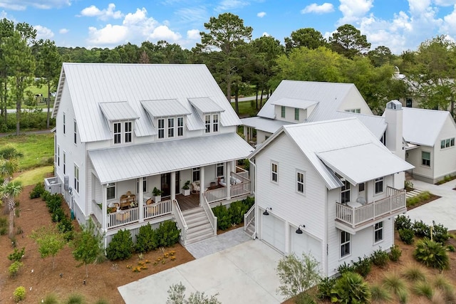 3023 Eventide Dr, Johns Island, SC 29455 - view of front of home featuring covered porch, an attached garage, concrete driveway, metal roof, and stairs