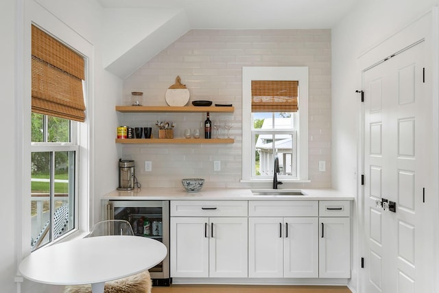 3023 Eventide Dr, Johns Island, SC 29455 - kitchen with a sink, wine cooler, backsplash, and light countertops