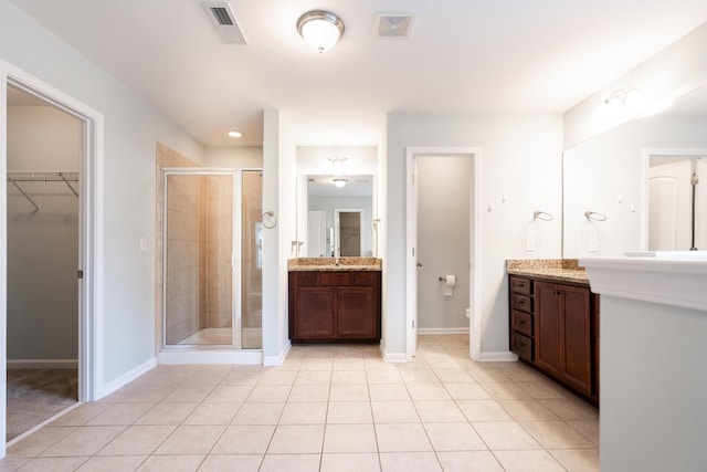 7217 Mossy Creek Ln, Hanahan, SC 29410 - bathroom featuring a shower stall, vanity, a walk in closet, and baseboards